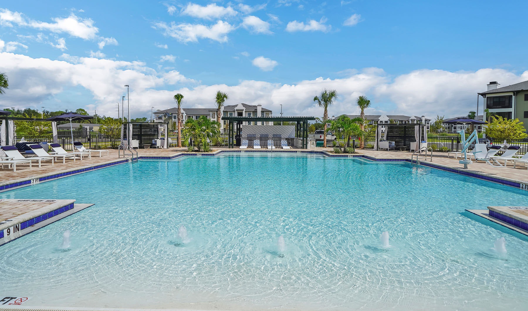 large, outdoor swimming pool with in-pool fountains Style Everywhere You Look